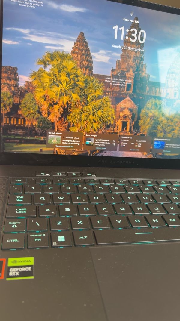 The repaired laptop switched on and running, screen intact